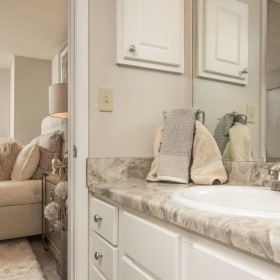 Spacious bathrooms with everything you need a bathroom with cabinets a mirror and a sink